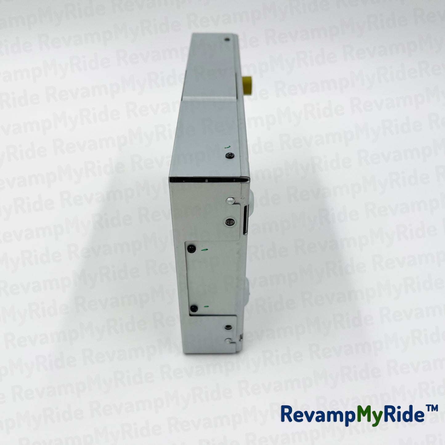 Metallic device on a white textured background with 'RevampMyRide' branding.