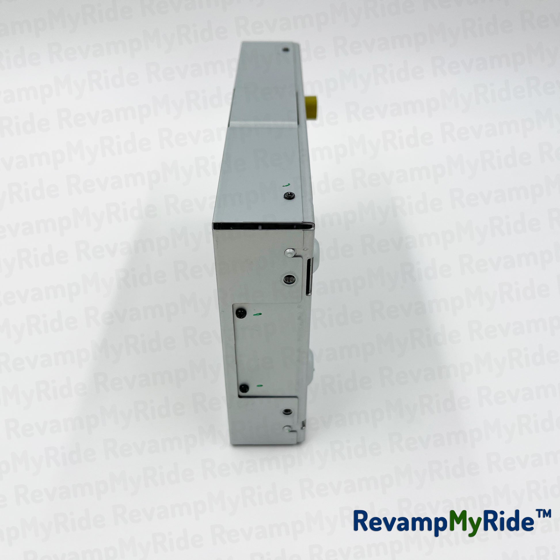 Metallic device on a white textured background with 'RevampMyRide' branding.